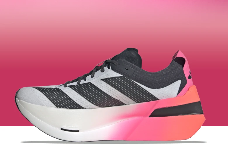 A white and grey runner with a thick, gradient pink sole is displayed against a pink and white gradient background.